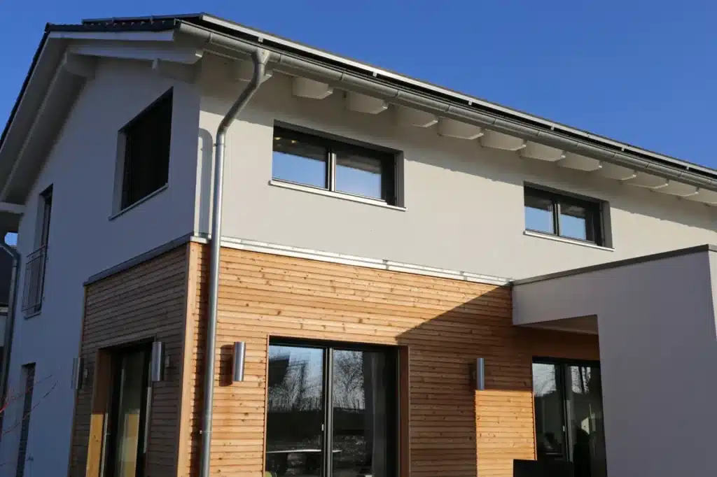 bardage bois sur façade extérieure d'une maison moderne avec finitions en bois naturel et menuiseries élégantes pour une durabilité optimale.